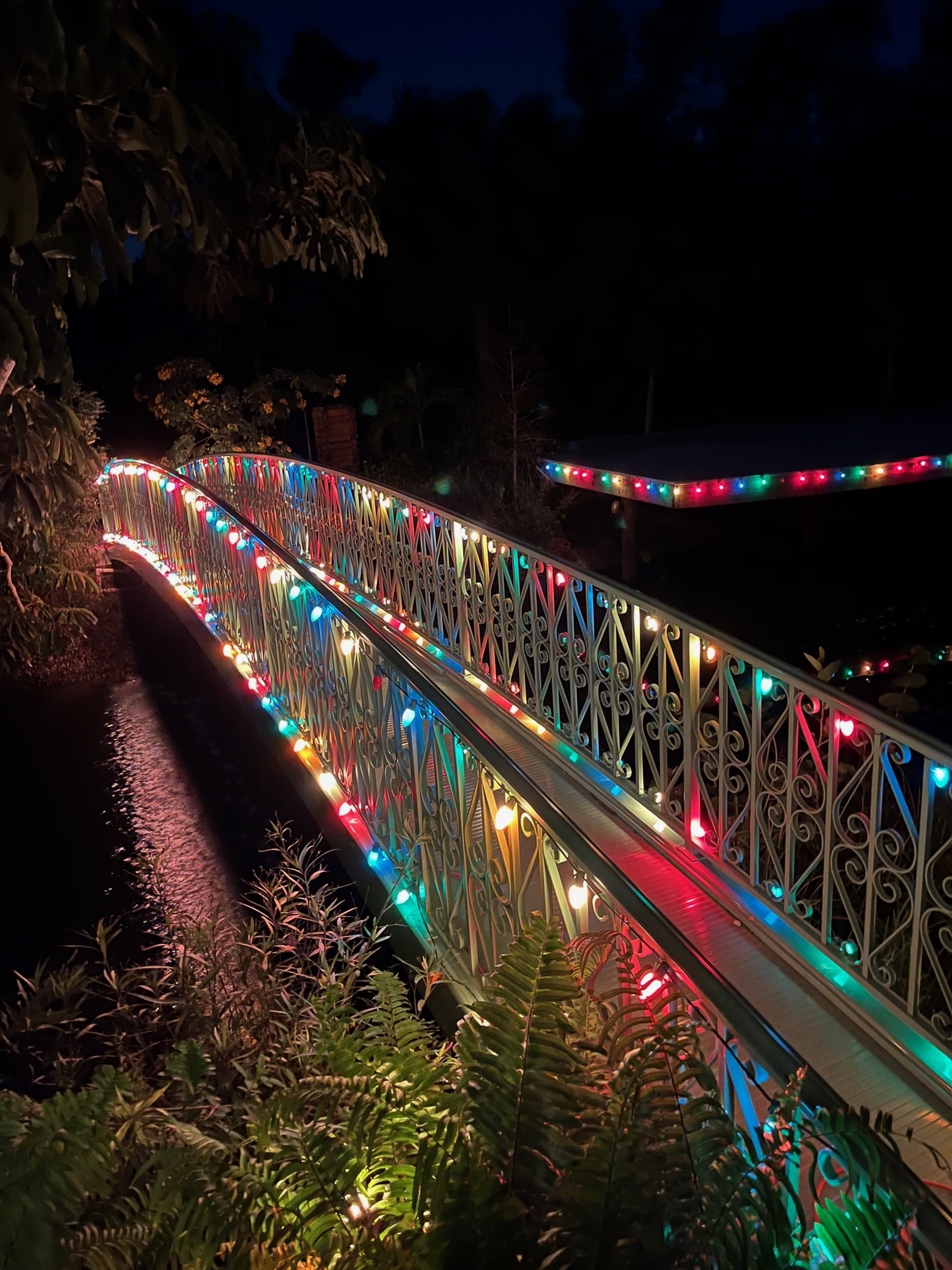 Bridge to the island decorated with colorful Christmas lights