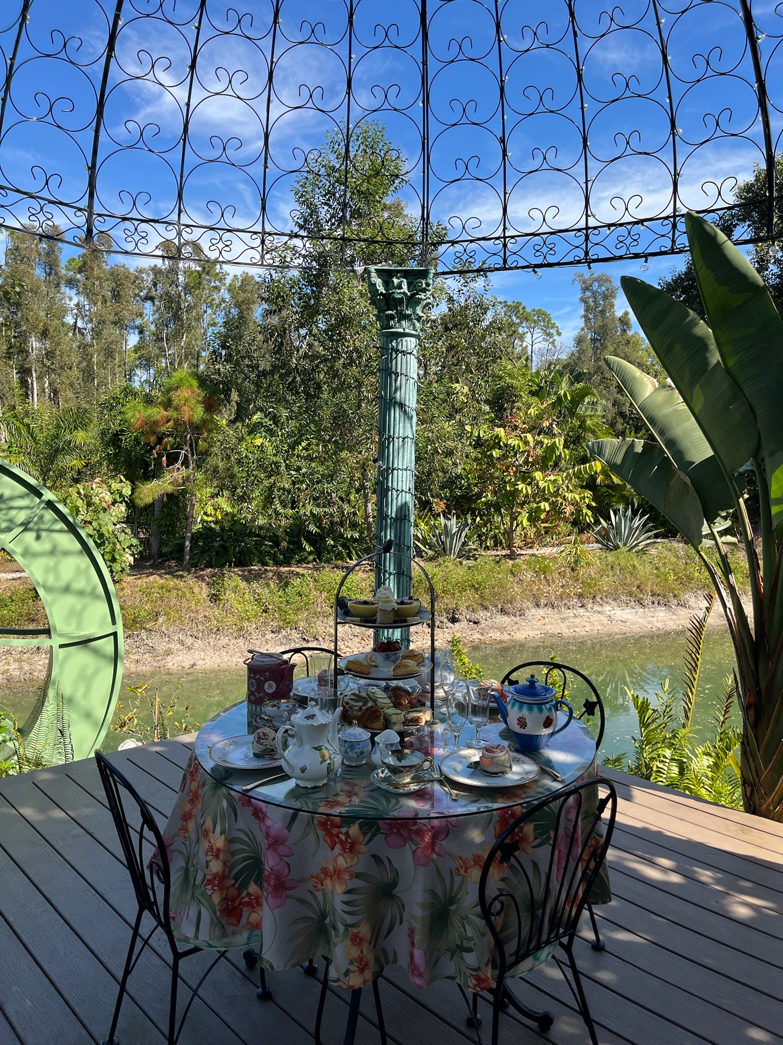 Tea service setup in gazebo overlooking the tranquil pond